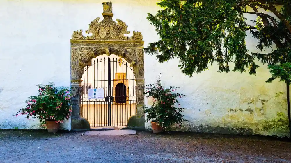 the carved baroque stone gateway into the manor courtyard