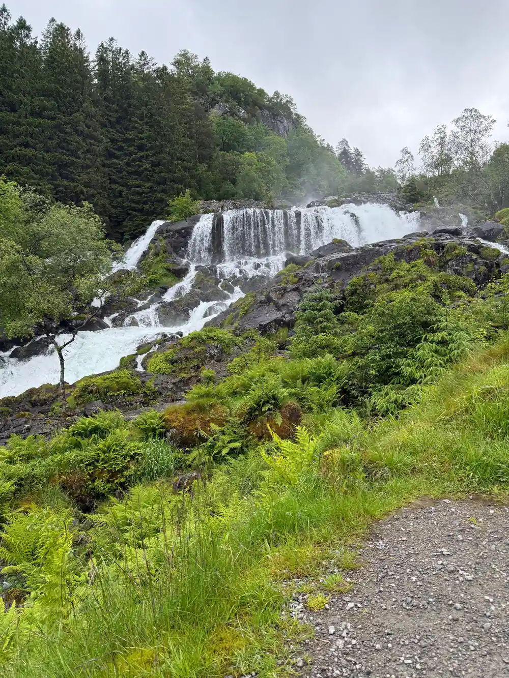 a long cascade beside the gravel path up from the village