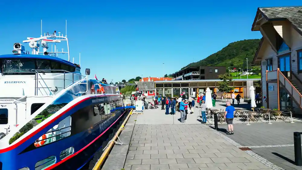 the Rodne catamaran alongside the quay with passengers gathered on the terminal apron